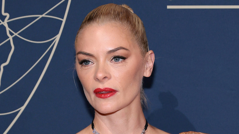 Close up of Jaime King smiling in black and white wrap
