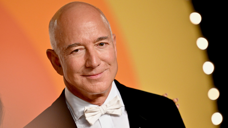 Jeff Bezos posing for photos in a tuxedo with a white bow tie
