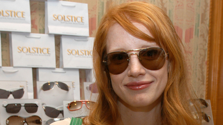 Jessica Chastain smiling in sunglasses