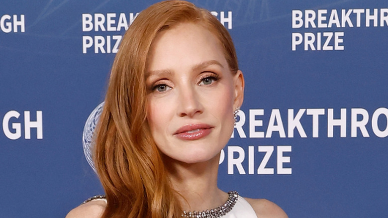 Jessica Chastain posing in a white dress at a 2025 event