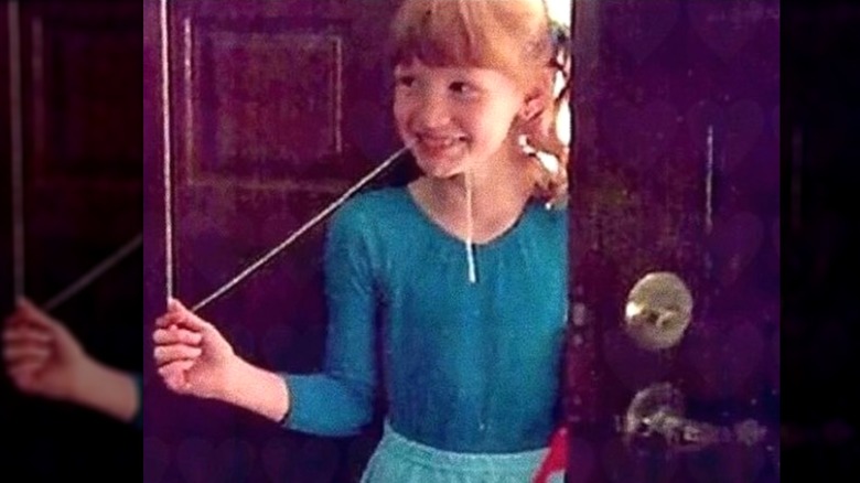 Jessica Chastain as a kid smiling a blue dress