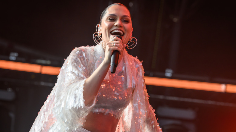 Jessie J singing in a white sequinned outfit