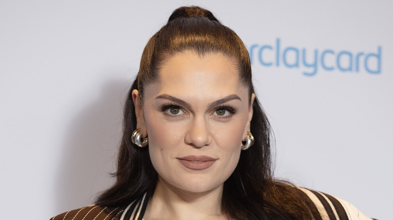 Jessie J wearing brown lipstick with a half updo