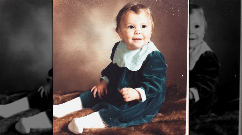 Baby photo of Jessie J wearing a green velvet dress