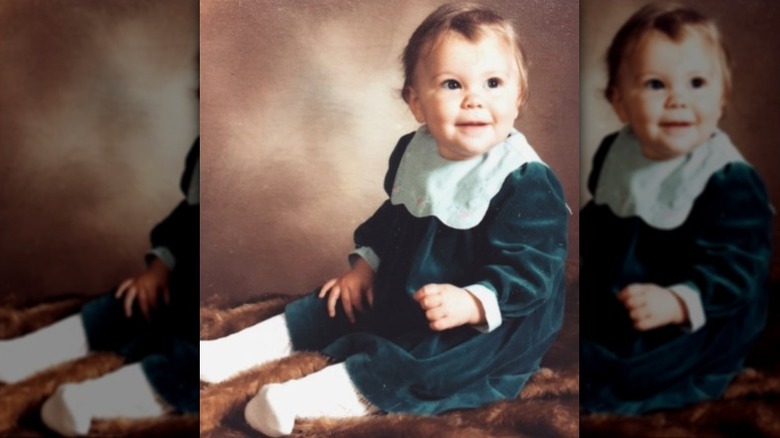 Baby photo of Jessie J wearing a green velvet dress