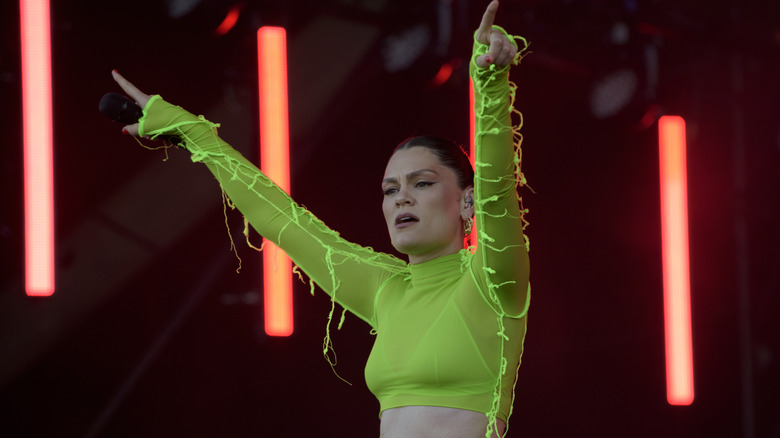 Jessie J performing in a neon green crop top
