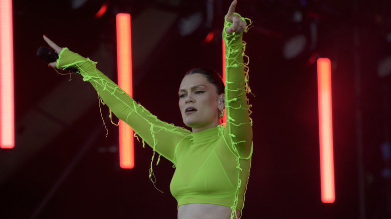 Jessie J performing in a neon green crop top