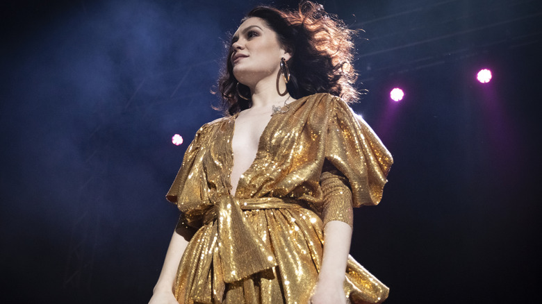 Jessie J performing in a golden tie-up dress