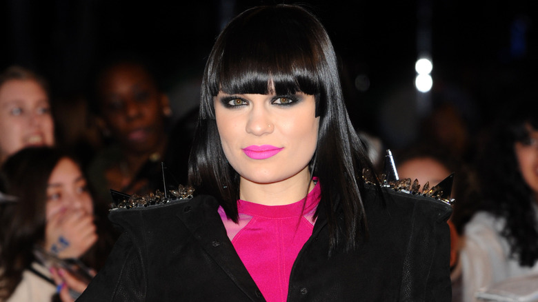 Jessie J in a hot pink and black outfit with her iconic fringe