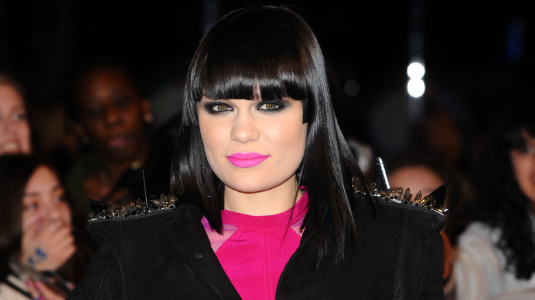 Jessie J in a hot pink and black outfit with her iconic fringe