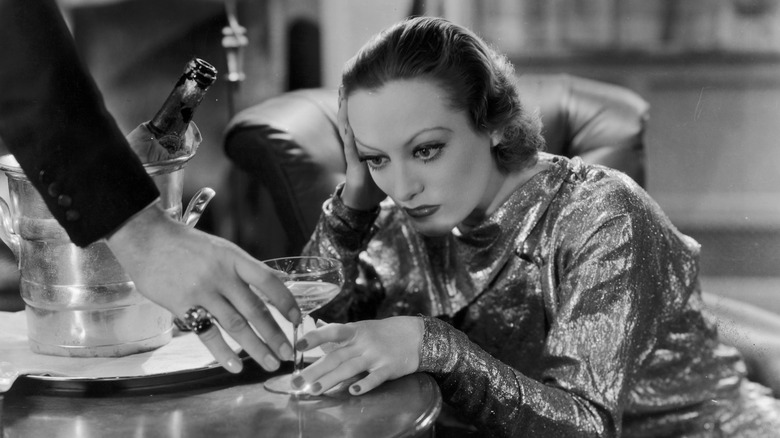 Joan Crawford staring at a martini glass