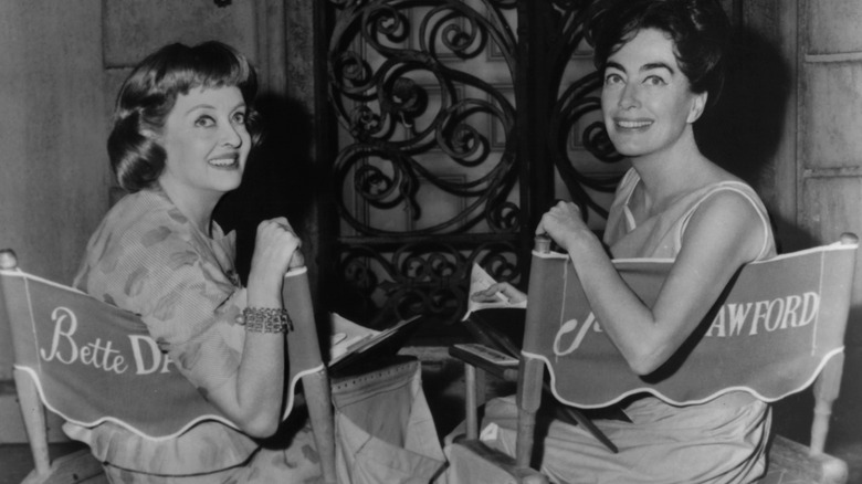 Bette Davis smiling with Joan Crawford