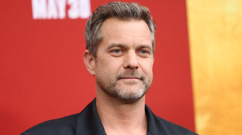Joshua Jackson posing for photos in a black suit jacket