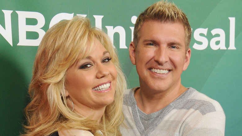 Julie and Todd Chrisley smiling at an NBCUniversal event