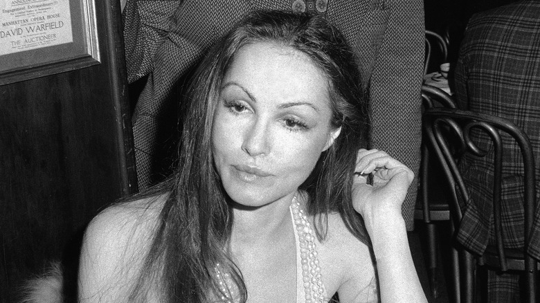 Julie Newmar sitting at a table