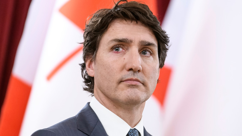 Justin Trudeau in front of Canadian flag