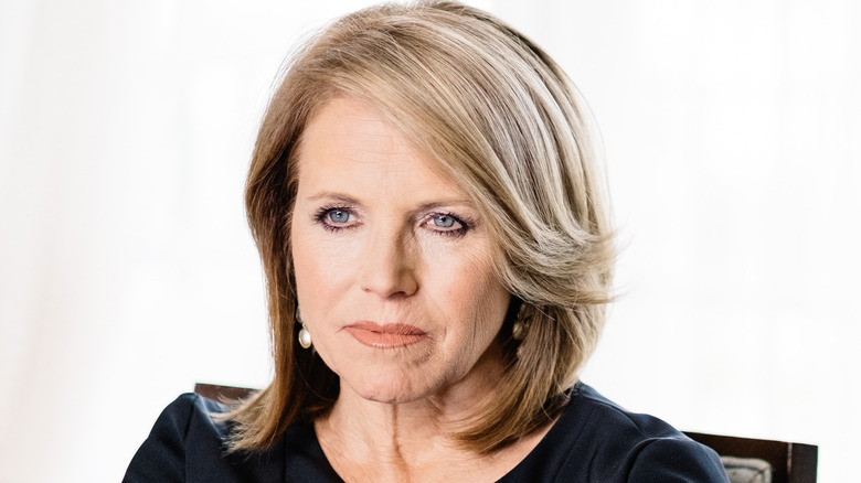 Katie Couric looking on 