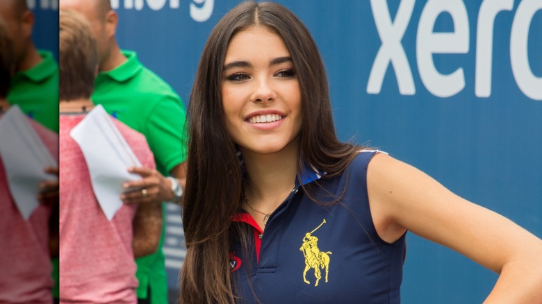 Madison Beer posing with her hand on her hip at kids' tennis event