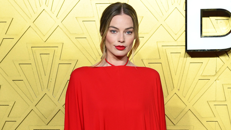 Margot Robbie wearing a red dress for the UK premiere of Babylon