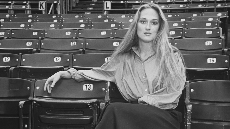 Young Meryl Streep sitting in an empty theater