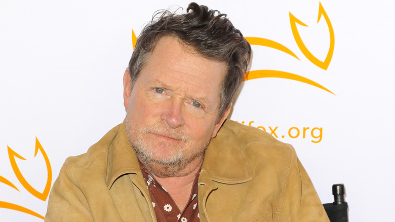 Michael J. Fox sitting in front of white backdrop