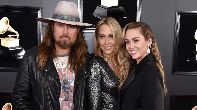 Billy Ray, Tish, and Miley Cyrus posing at Grammy Awards