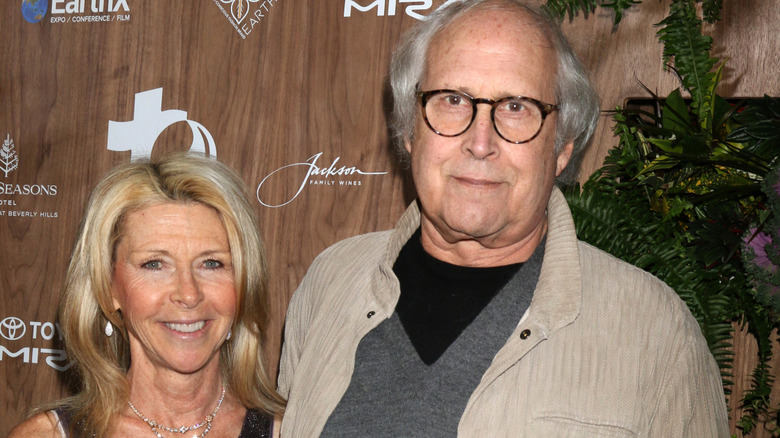 Closeup of Jayni and Chevy Chase posing at event