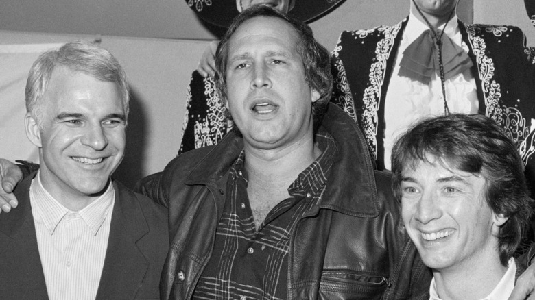 Chevy Chase with his arms around Steve Martin and Martin Short in 1986