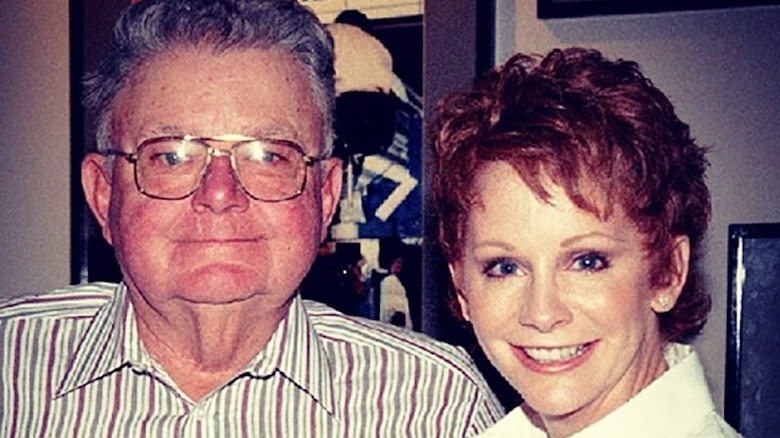Reba McEntire smiling with her father