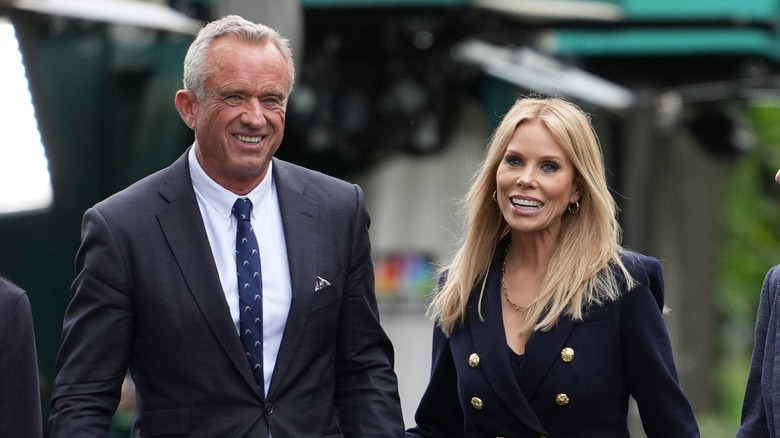 RFK Jr. and Cheryl Hines smiling as they walk next to each other