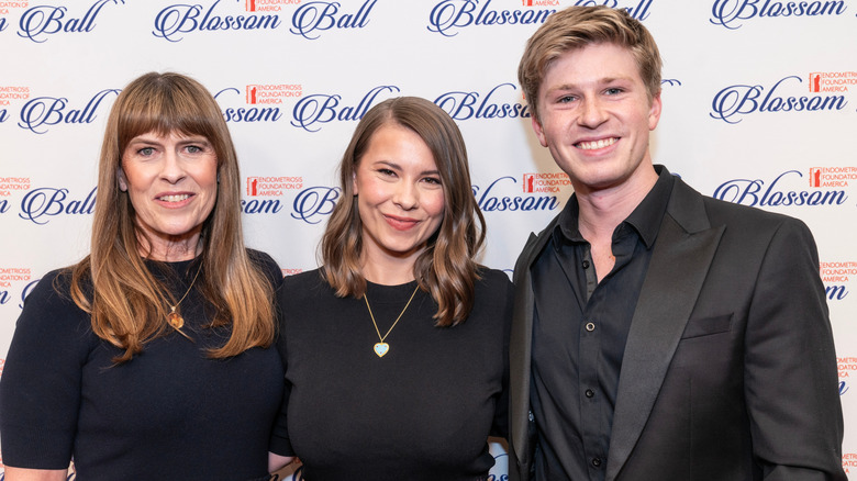 Terri, Bindi, and Robert Irwin in front of white background.