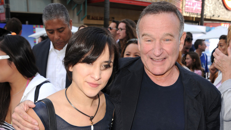 Robin Williams' arm around Zelda Williams in a crowd