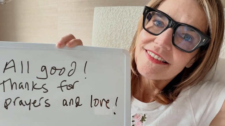 Savannah Guthrie holding a whiteboard updating her followers on her health
