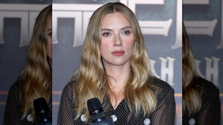 Scarlett Johansson holding a microphone at a press conference