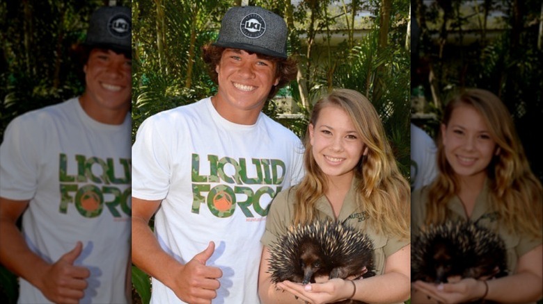 Bindi Irlwin smiles while holding an echidna with her husband (2022)