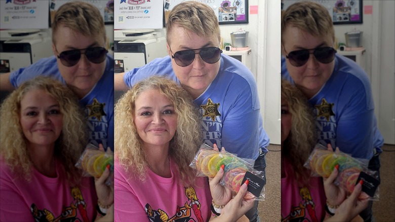 Amanda Halterman and Katie Slaton posing for photos with a cookie