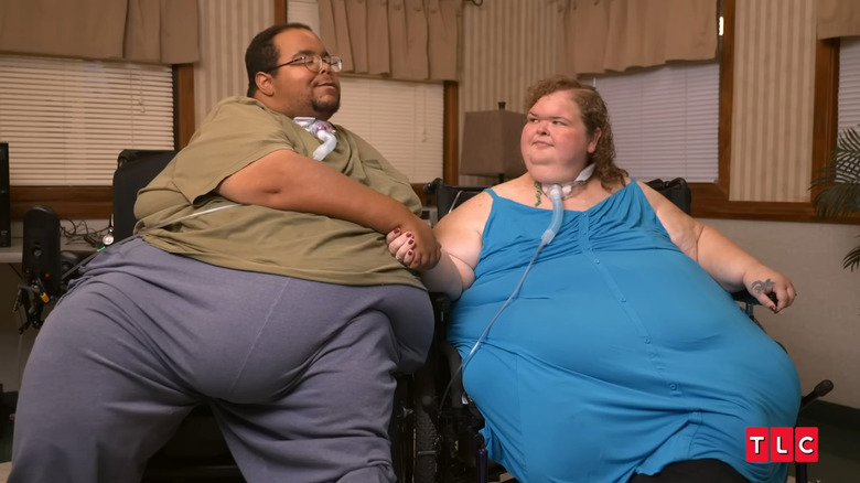 Amy Slaton holding Caleb Willingham's hand
