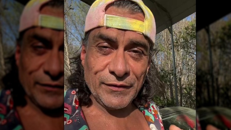 Jonathan Joss filming Instagram video with backward hat