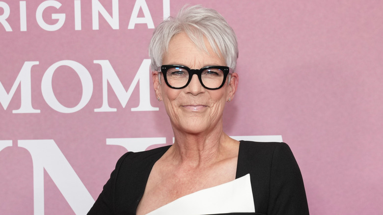 Jamie Lee Curtis at the Tribeca Film Festival posing in front of a pink background