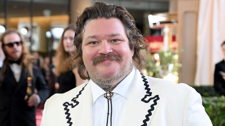 Matty Matheson attending the Golden Globes wearing a white suit