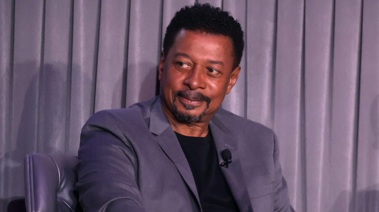 Robert Townsend speaking on stage at a screening