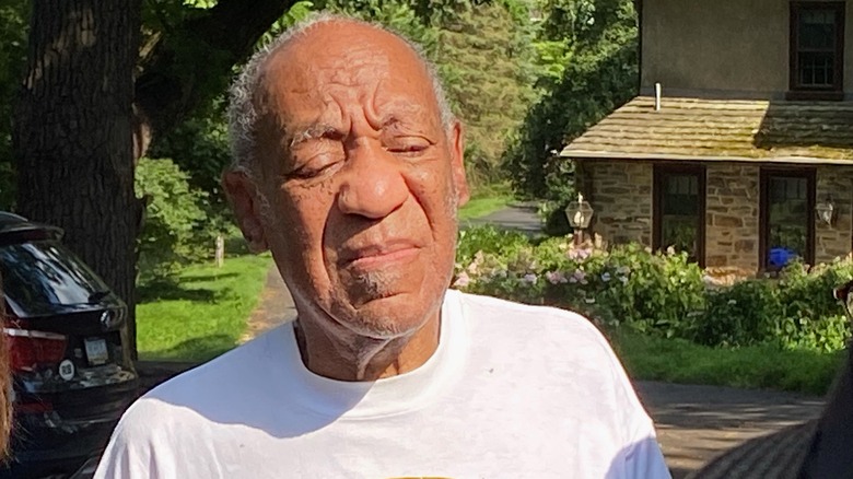 A now-blind Bill Cosby with his eyes closed outside after his release