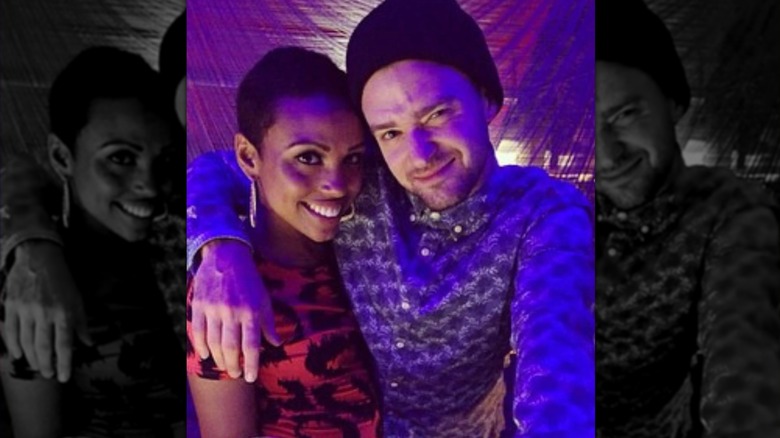 Justin Timberlake smirking with his arm around a smiling Nicole Hurst