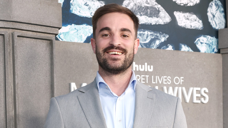 Conner Leavitt at an event wearing a grey suit