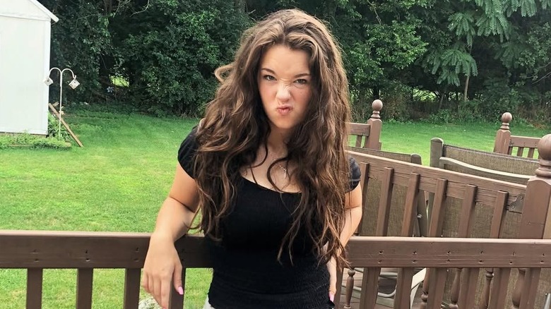 A brunette Baylen Dupree at home in her garden