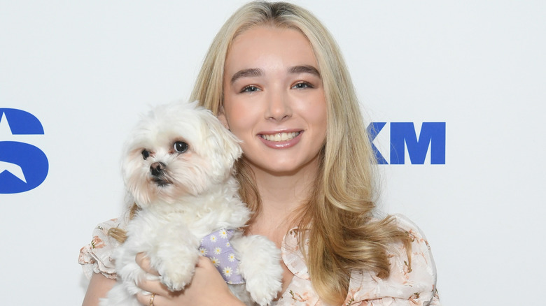 Baylen Dupree and her dog, Fluffy, posing on step-and-repeat