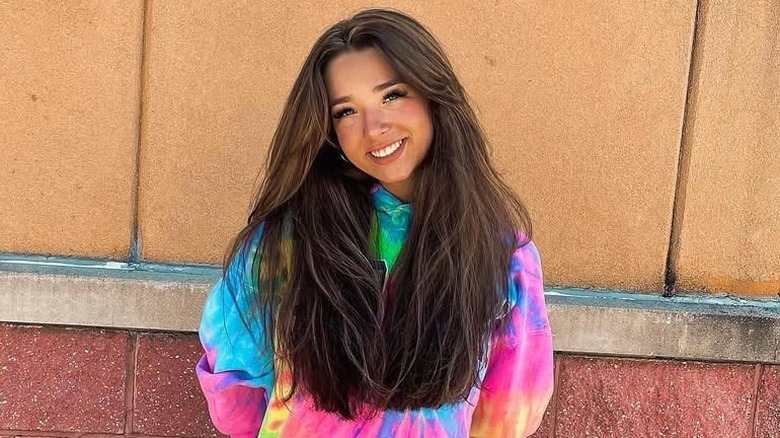 Baylen Dupree with dark hair smiling in the street