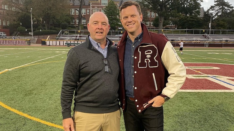Willie Geist in his old football jacket, standing on a football field next to his old coach Drew Gibbs