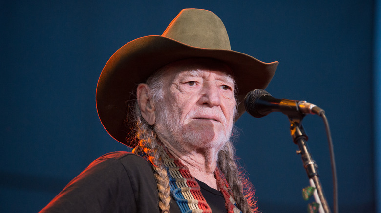 Willie Nelson performing on stage