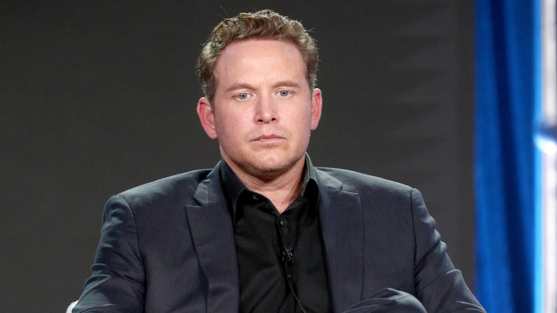 Cole Hauser staring intensely at something at an event